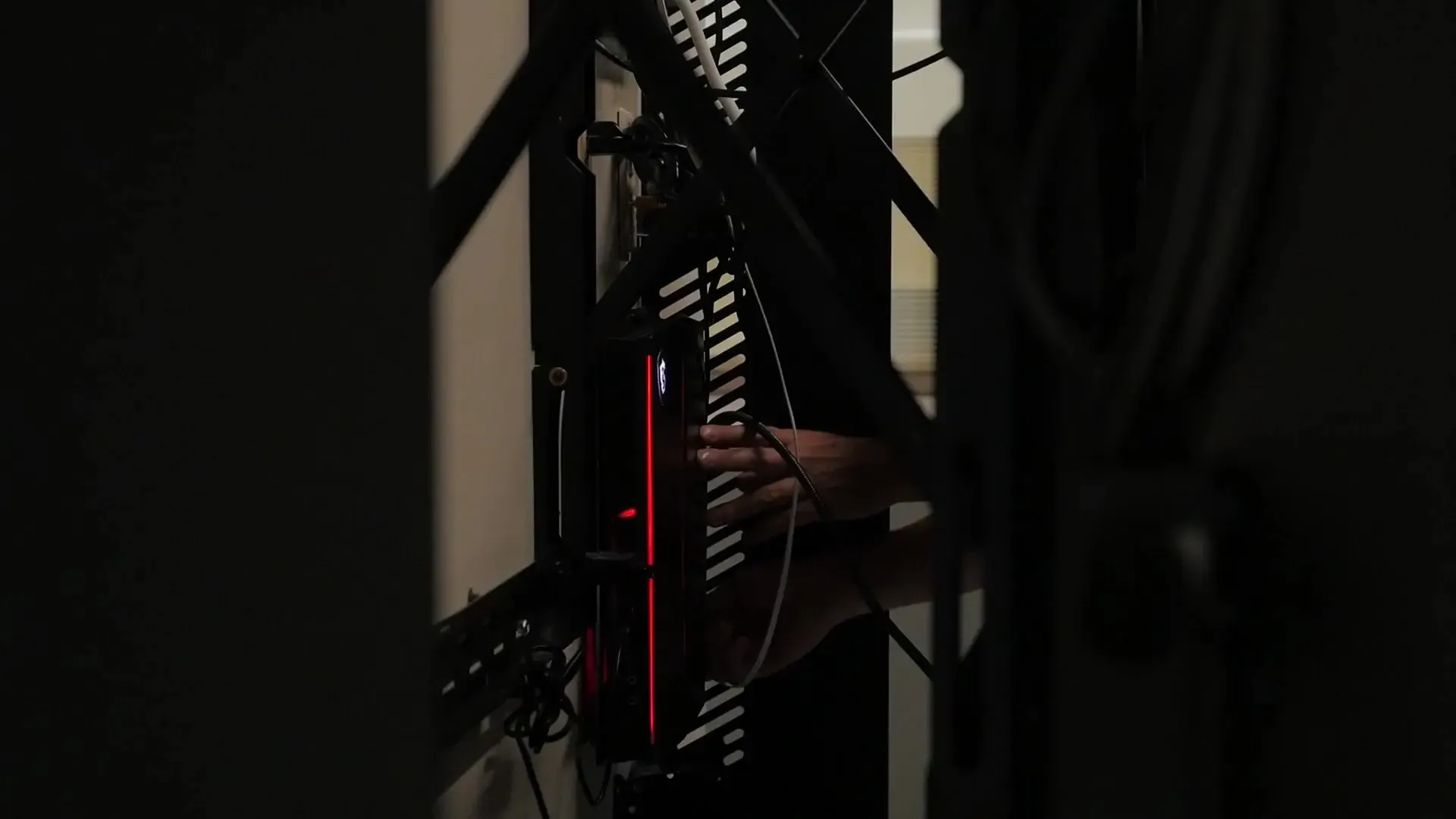 Wall-mounted computer behind screen showing secure installation