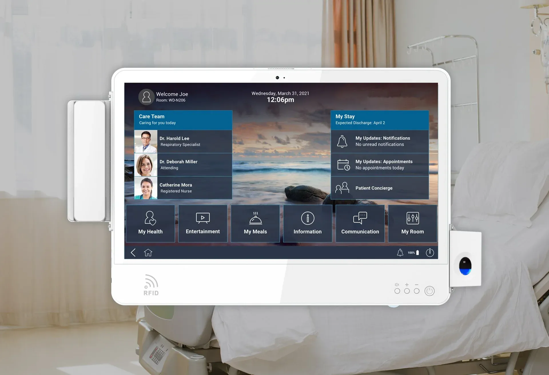 Oneview bedside tablet mounted on a hospital bed arm showing a patient dashboard with care team, stay details, meals, entertainment, and room controls